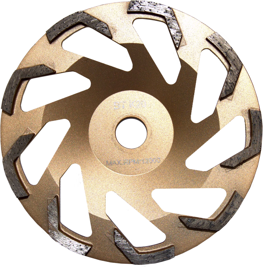 Close-up photograph of a segmented diamond grinding cup wheel viewed from above. The tool has a metallic gold-painted steel body with a central arbor hole and multiple curved radial ventilation cutouts. Around the outer rim are evenly spaced, raised diamond segments with a textured, dark grey appearance and visible wear marks, arranged in a staggered spiral pattern to aid material removal. The wheel surface shows a matte metallic finish and faint stamped markings near the center indicating manufacturer codes and maximum RPM; the design and segment shape suggest it is intended for grinding concrete, stone or similar hard materials with an angle grinder or concrete grinder.